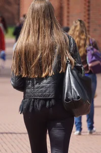 Pretty girl walking in tight black pants