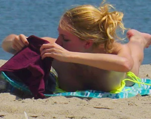 Sexy ass blonde milf on the beach in a thong with cameltoe and bending over