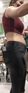 Latina in Maroon crop top and tight black jeans