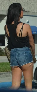 Brunette in short denim shorts showing a little cheek