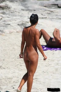 Smoking milf at a nude beach with a hairy pussy