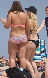 Two thick white girls in bikinis on the beach with big asses