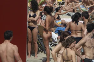 Topless girls on a beach in Barcelona
