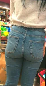 Skinny brunette with a nice booty in line in tight jeans