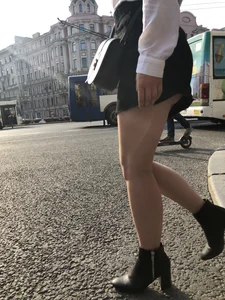Awesome candid chick wearing a blouse and a skirt crossing the street on high heels, showing a little cheek