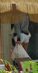 Girl next door teen neighbor bringing in groceries in short jean shorts