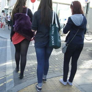 Girl in a pink skirt and stockings accidentally showing some cheek