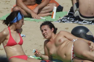 Topless girls on a beach in Barcelona