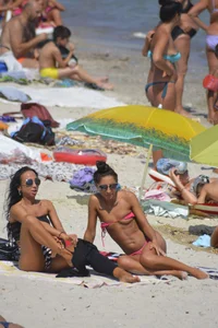 Sexy beach babe in pink bikini makes it a string bikini
