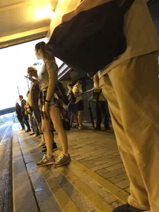 Cute Teen in Shorts on the Tram Stop