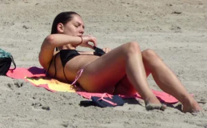 Brunette on the beach in a bikini with nice ass and small boobs