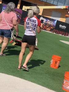 Bunch of girls in various outfits at a Cardinals baseball game
