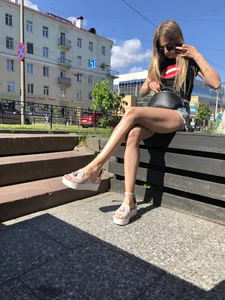 Girl in Denim Shorts with Amazing Hot Legs Fixing Her Sandals Street Candid Photo Gallery