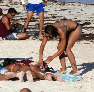 Tattooed beach babe in black thong with a nice ass
