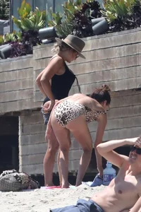 Ashley Tisdale in cheetah print swimsuit on the beach in Malibu