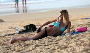 Sexy blonde laying out in black thong bikini