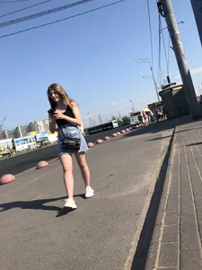A very cute street candid girl wearing a denim fringed skirt passing by, great legs