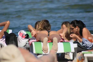 A couple sexy girls laying out on the beach