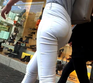Skinny babe with a nice ass in tight white jeans walking