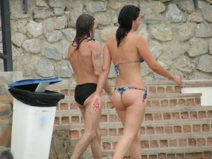 Sexy girl in a blue floral thong bikini at the beach