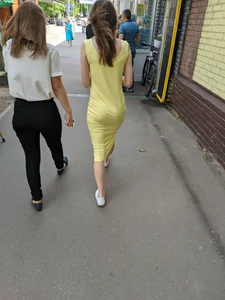 Hot booty of a candid girl walking down the street wearing a yellow tight dress
