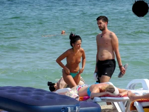 Brunette topless babe with cute tits and a nice ass in a thong bikini