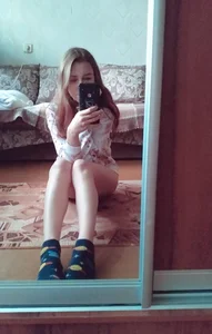 Girl with Skinny Legs Sitting on the Floor Home Mirror Selfie