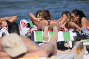A couple sexy girls laying out on the beach