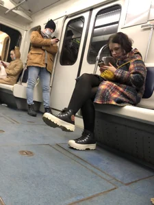 Cute Teen in Black Pantyhose And Sneakers Tying Her Shoelaces in a Subway Train