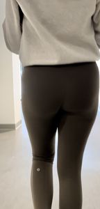Following the blonde with Fake lashes in green leggings