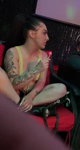 Tattooed girl sitting with crossed legs