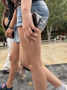 Candid teen wearing denim shorts passing by, nice legs
