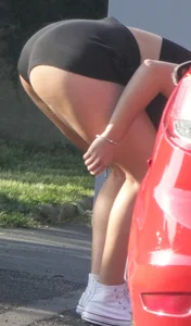 Girl in shorts bends over