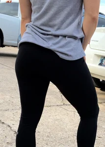 Sexy girl sitting in sexy position on a couch in leggings