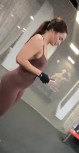 Brunette in the gym with big tits