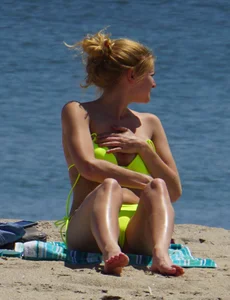 Sexy ass blonde milf on the beach in a thong with cameltoe and bending over