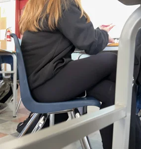 College teen in leggings sitting at her desk in class creepshots