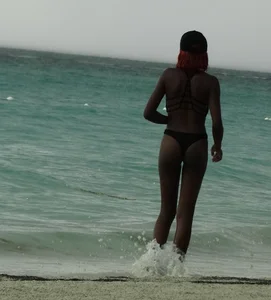 Candid black family, milf and teens on the beach in bikinis