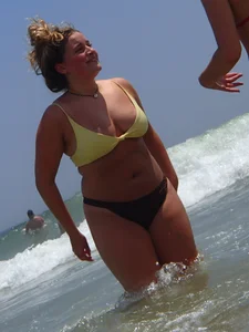 Thick girl and her skinny friend in bikinis at the beach