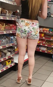 Girl With Nice Chubby Legs in Flip-Flops Standing on Her Tiptoe in a Supermarket Creepshot