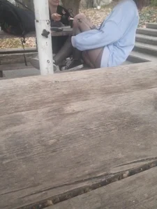 College teen in ripped pantyhose sitting outside