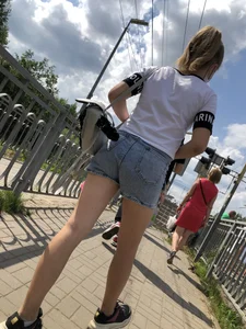 Cute Girl in Denim Shorts Walking Down a Railway Station Gallery