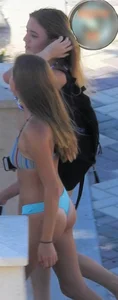 Two sexy friends on the beach in thong bikinis