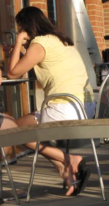 Lady in flop flops while eating showing her feet