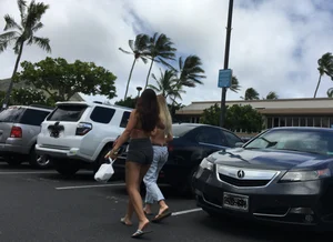 Girl with a nice ass in shorts in the parking lot showing her bikini line