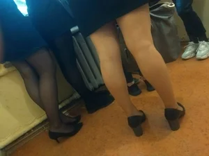 Candid College Girl's Legs in Pantyhose And Shoes on Heels Closeup Photo