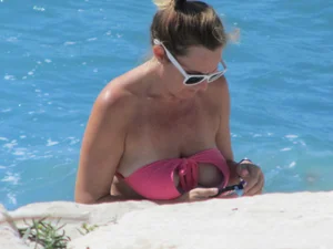 Mature milf's tits flashing in the pool