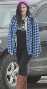 A cute brunette in leggings boots and hat