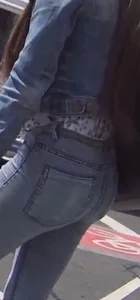 Another girl in tight jeans waiting for the bus