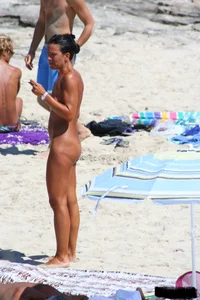 Smoking milf at a nude beach with a hairy pussy